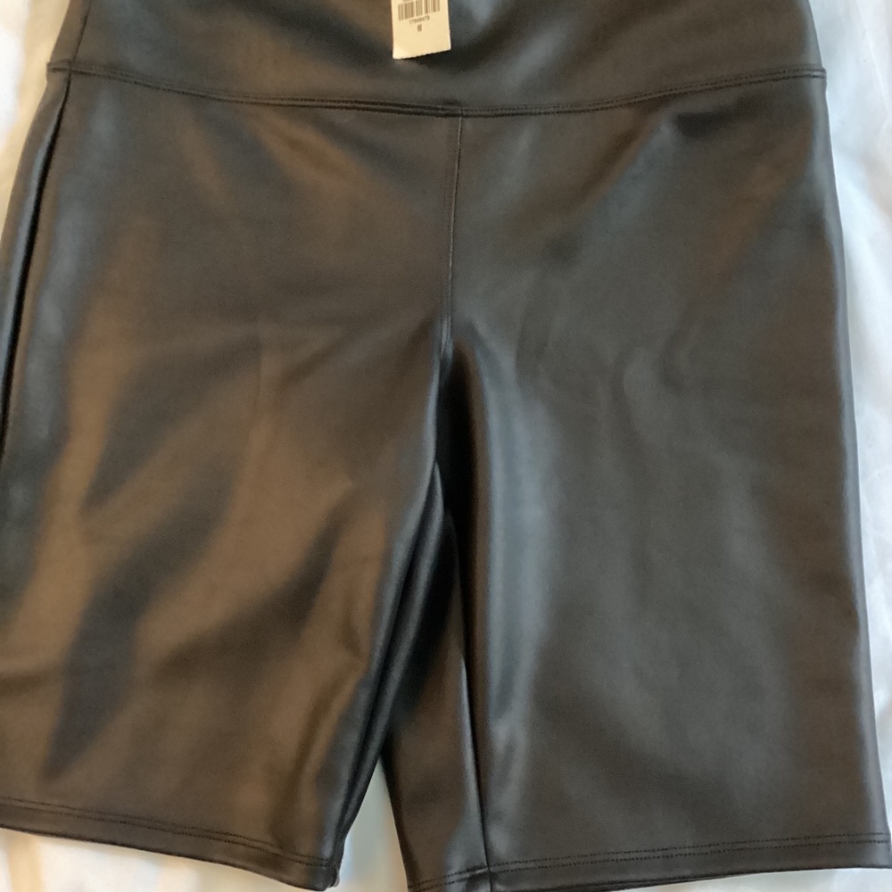 Express black faux leather biker shorts in size M
